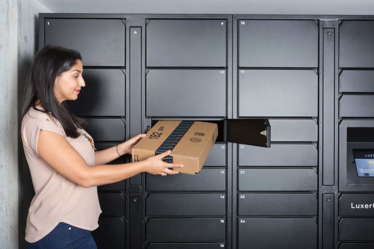 Woman grabbing Package from Add-On Unit Luxer One Parcel Locker